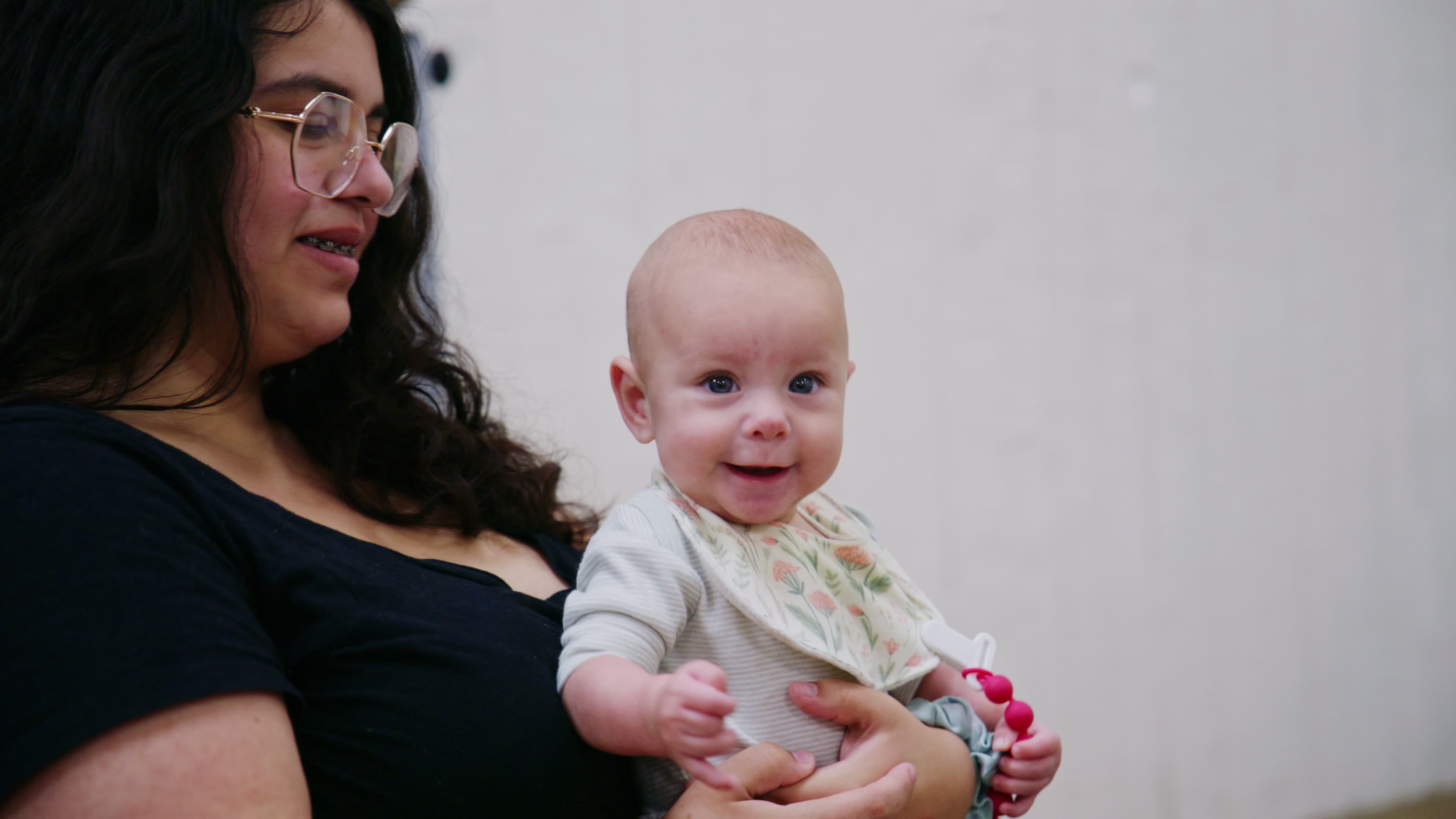 A mother holding her smiling baby